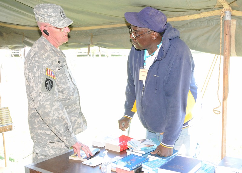 EBSD12.jpg - Pleasanton, CA  --  Theodore Thomas, a Marine Corps Vietnam War veteran stopped by the Chaplain’s tent to receive some religious literature from US Volunteers Chaplain, Tom Gutshall during the East Bay Stand Down 2010 held in Pleasanton, California on August 5-8, 2010.Photo Credit: CPT Anthony John, USAR Joint Special Troops Support Command Public Affairs Officer